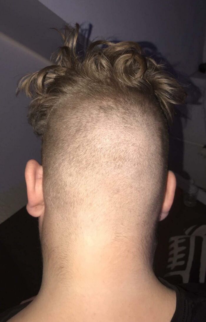 Uneven haircut from the back showing a hair-cutting-dyeing-fail with shaved and longer sections.