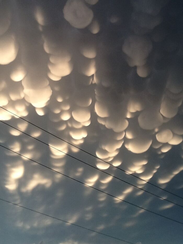 Fascinating cloud shapes forming in the sky, creating an unusual and captivating pattern with a soft glow.