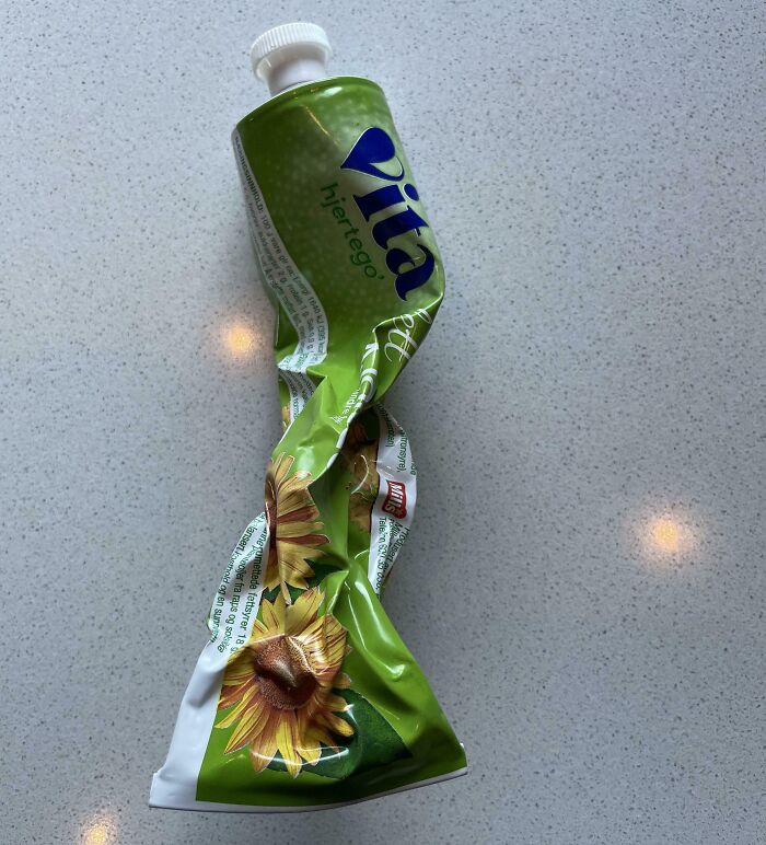 Crushed tube of sunflower oil on a countertop, linked to infuriating behavior by wives and girlfriends.