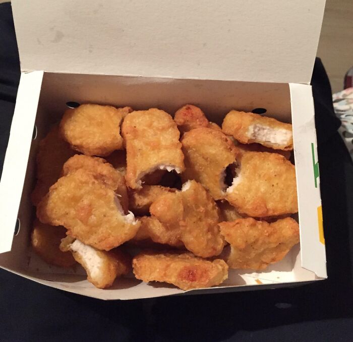 Box of chicken nuggets with bites taken out, illustrating humor related to infuriating wives and girlfriends.