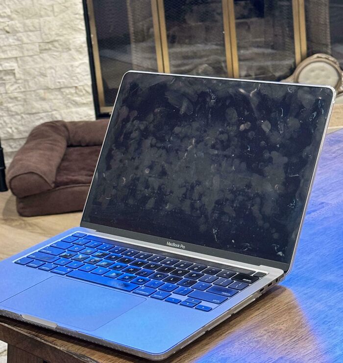 Dirty laptop screen on a table, possibly reflecting infuriating behavior of wives or girlfriends.