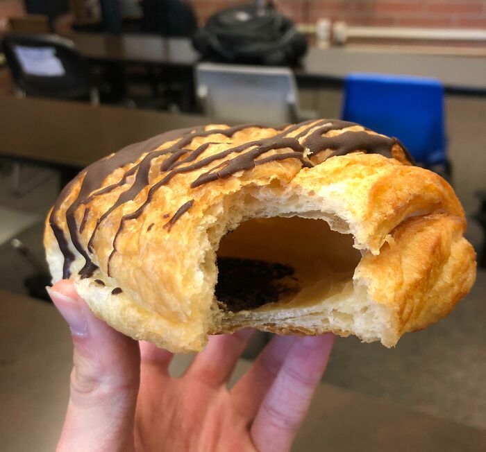 A hollow chocolate croissant showing buyer's remorse, highlighting regret after spending money.