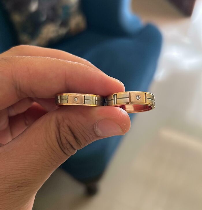 Close-up of two rings in hand, symbolizing regret after spending money.