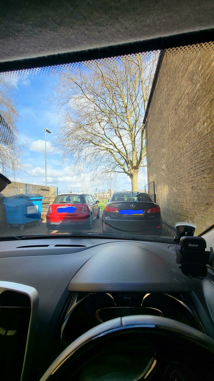 Cars blocking a narrow space, illustrating thoughtless parking.