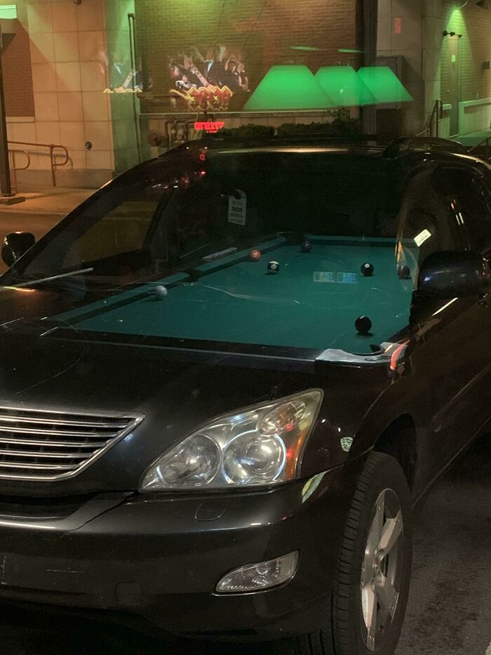 Car with a pool table inside, showcasing an interesting and not photoshopped photo.