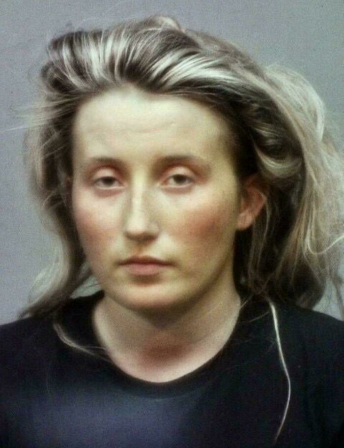 Woman with Renaissance painting style appearance, looking directly, with tousled hair and a neutral expression.