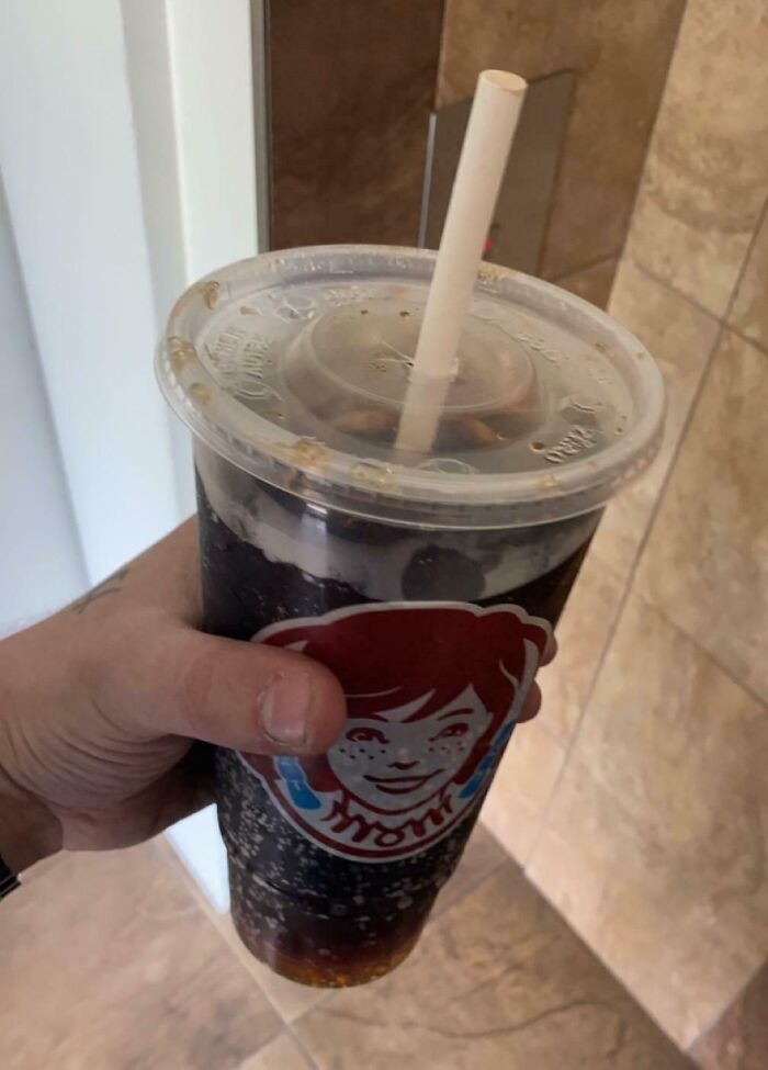 Mismatched straw and lid size on a drink cup, causing irritation.