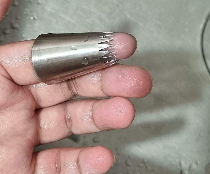 Finger stuck in a metal icing tip, showcasing an irritating and mildly infuriating situation.