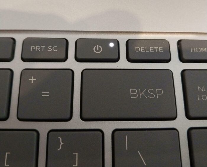 Close-up of a keyboard with an irritating power button placed next to the delete key.