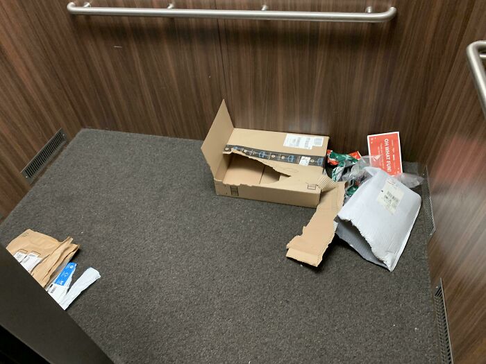 Discarded packaging left in an elevator, showcasing inconsiderate behavior.