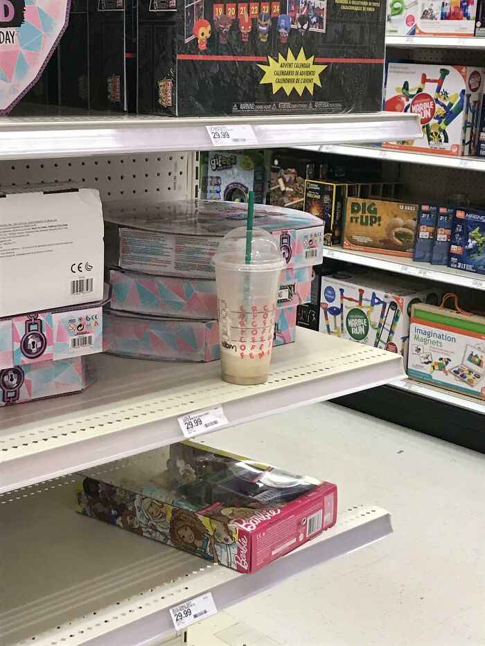 Abandoned coffee cup left on a store shelf.