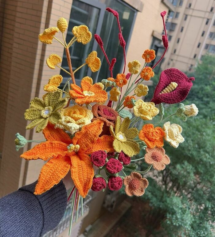Crochet flowers in vibrant fall colors, a creative Thanksgiving home decoration idea.