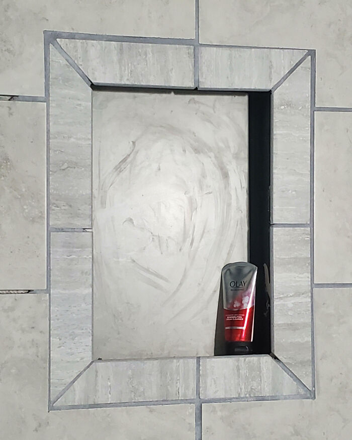 Shower niche with awkward tile alignment showcases a home improvement fail.