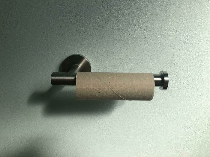 Empty toilet paper roll on a holder, symbolizing weaponized incompetence.