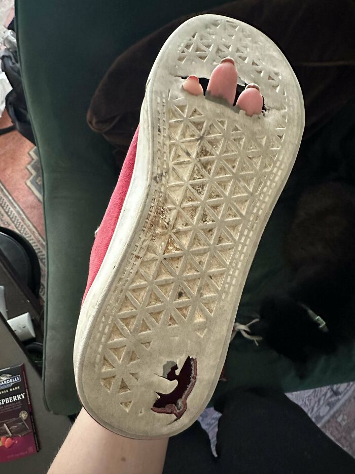 Worn-out shoe with holes exposing toes, illustrating weaponized incompetence in maintenance or repair.