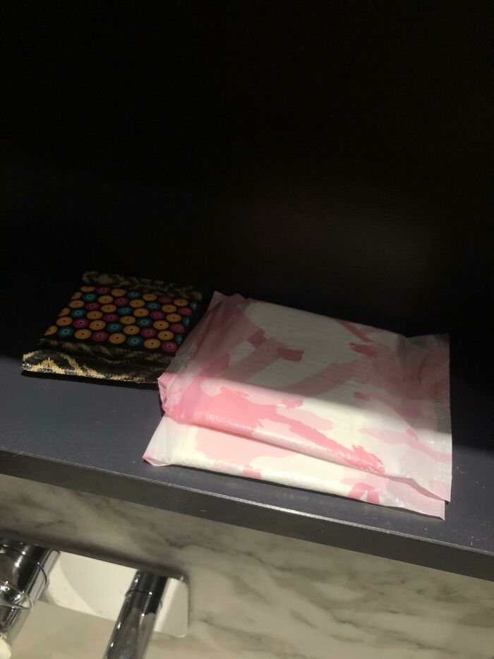 Colorful button pouch and pink patterned packs on a dark shelf, illustrating the concept of weaponized incompetence.