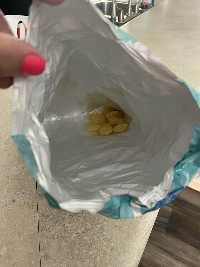 A mostly empty snack bag, illustrating the concept of weaponized incompetence with only a few crackers left inside.