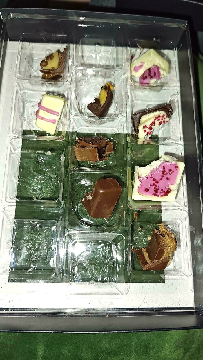 Empty chocolate tray with leftover bits, symbolizing weaponized incompetence in a disorganized manner.