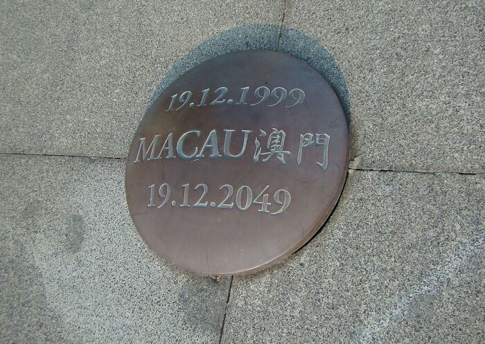Macau historical time capsule set for opening in 2049, marked with dates 1999-2049 on a bronze plaque.