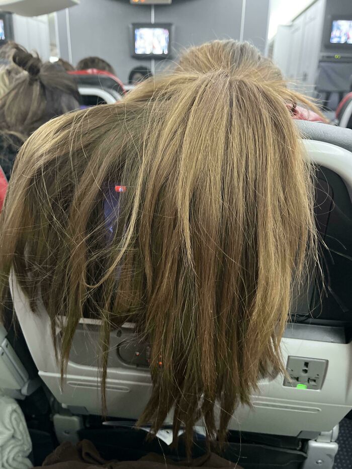 Long hair draped over airplane seat, a common issue with annoying plane passengers.