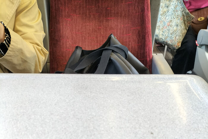 Bag occupying seat on public transport, frustrating fellow passengers.