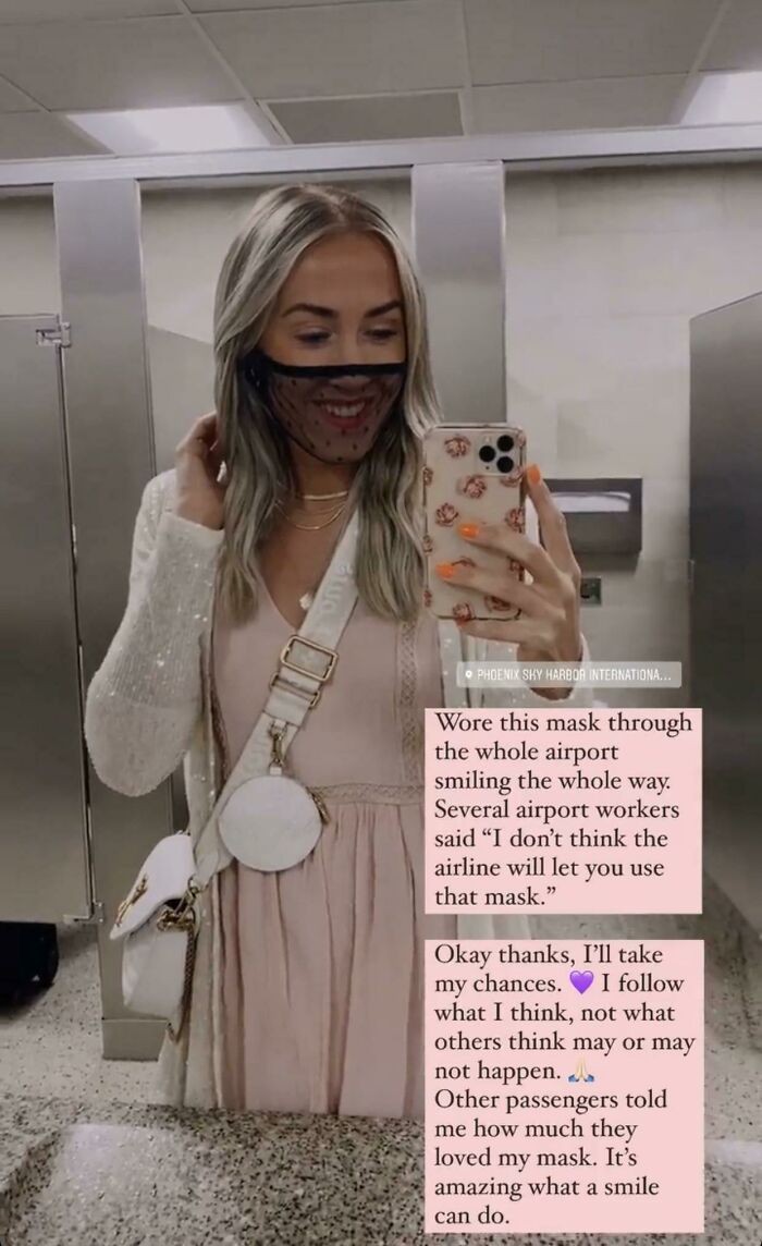 Woman in airport bathroom mirror selfie wearing a see-through mask, potential annoying plane passenger.