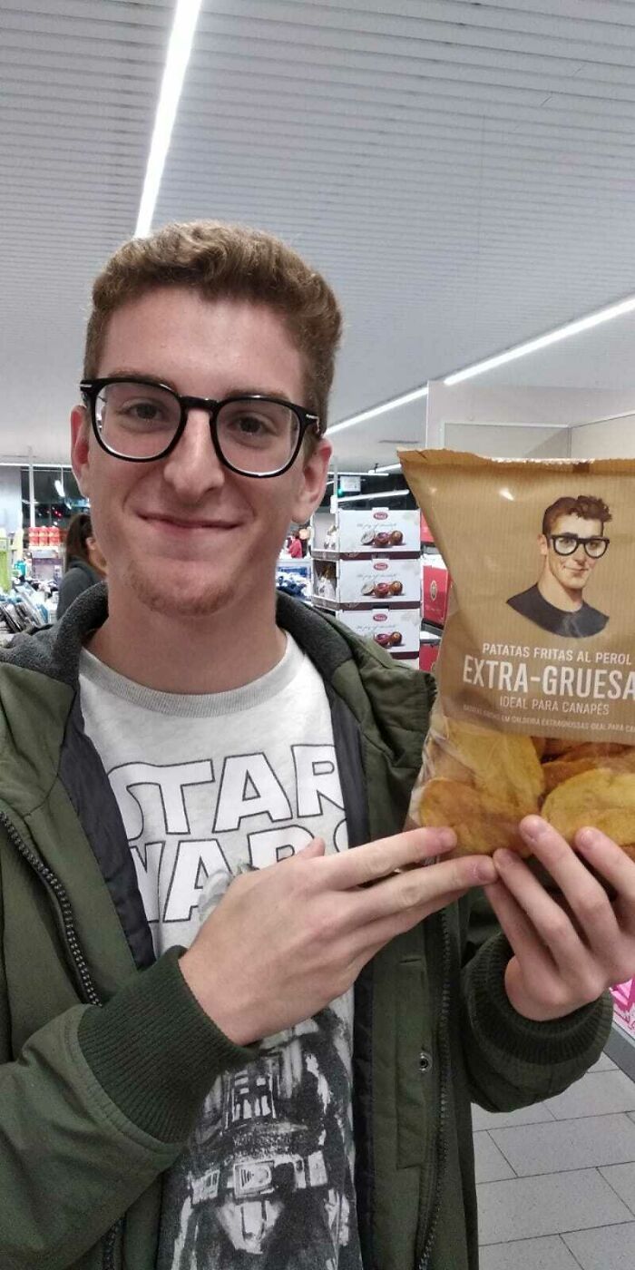 Man in glasses finds uncanny doppelganger on a snack package, showcasing a glitch in the matrix.
