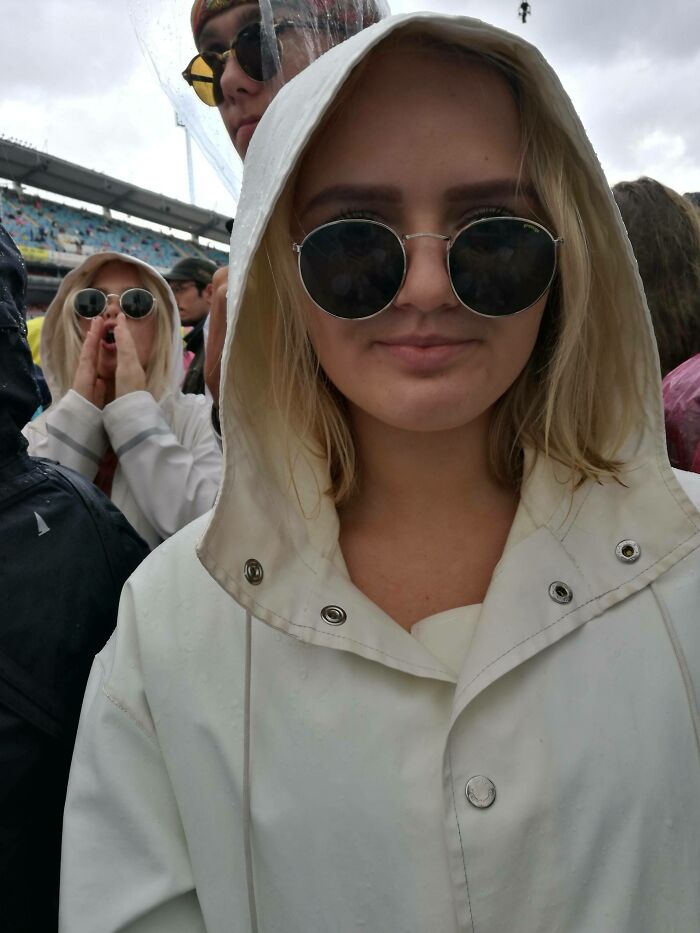 Person in a white hooded jacket and sunglasses, standing next to a lookalike in similar attire, showcasing uncanny doppelgangers.