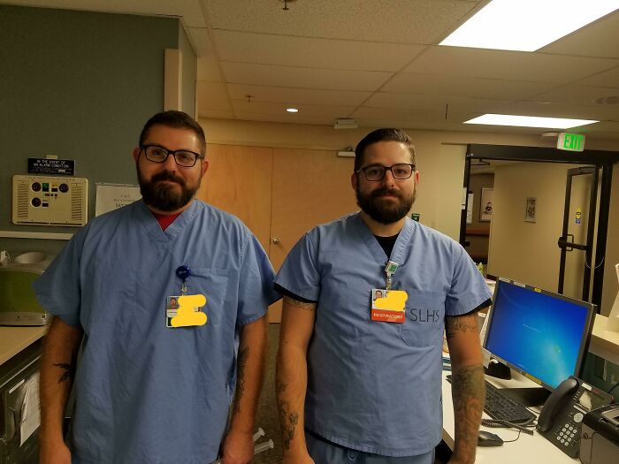 Two men in blue scrubs resembling uncanny doppelgangers, standing in a hospital setting.