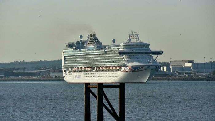 Cruise ship appears balanced on a narrow post, providing an interesting optical illusion, not photoshopped.