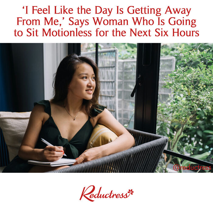 Woman sitting on a patio chair with a notebook, conveying a humorous fake headline about feeling the day slip away.