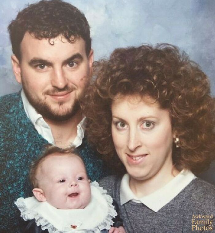 A family portrait with parents and baby, capturing an awkward moment typical of vintage family photos.