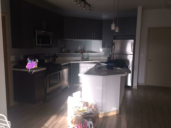 Modern kitchen with a floating bag casting a shadow, showcasing interesting not photoshopped photos concept.