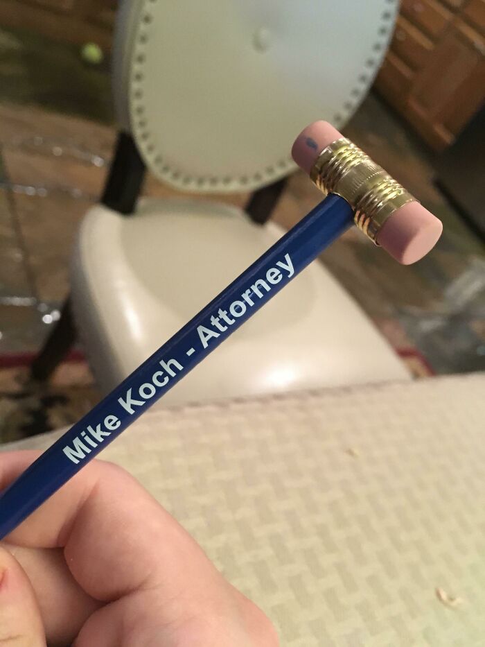 Creative designer pen resembling a gavel with "Mike Koch - Attorney" printed, capturing clever design innovation.