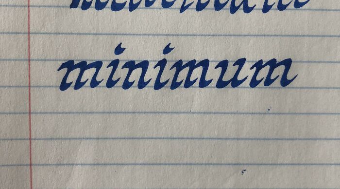 Calligraphy of the word "minimum" in elegant handwriting on lined paper.