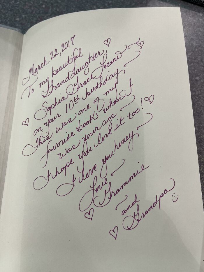 Elegant cursive handwriting on a birthday message from grandparents to their granddaughter, showcasing artistic penmanship.