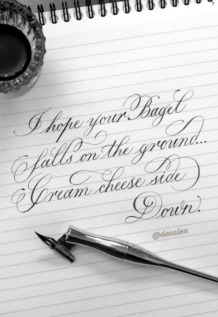 Elegant handwritten message on lined paper, showcasing exceptional handwriting skills with a fountain pen beside it.