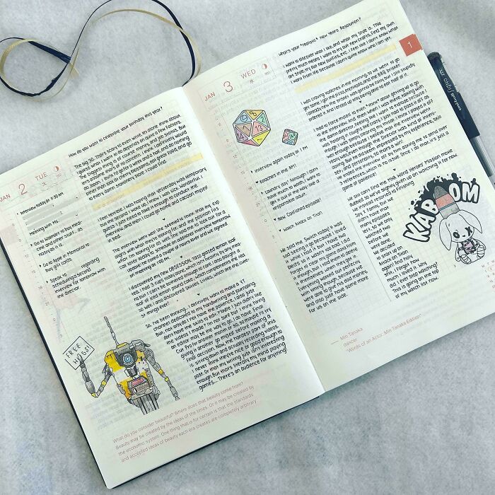 Handwriting skill displayed on an open journal with doodles and notes, showcasing neat lettering.