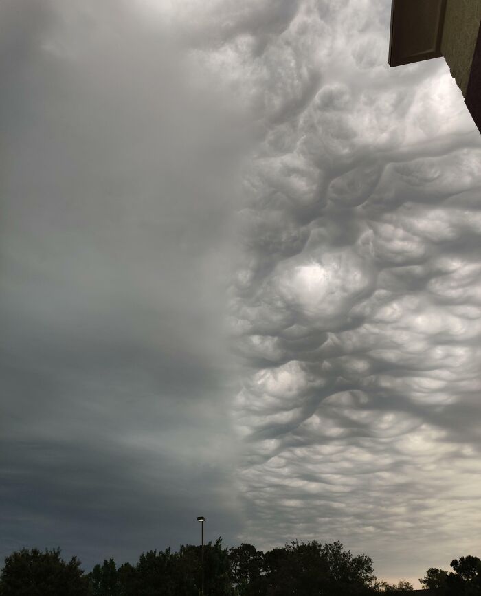 Mammatus clouds over a landscape, creating a dramatic and mesmerizing sky; an example of interesting, not photoshopped photos.
