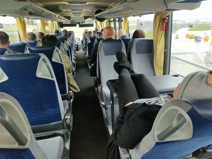 Putting Your Feet Up On A Table In A Bus Therefore Blocking The Only Four People Seats In A Bus Coming From The Airport