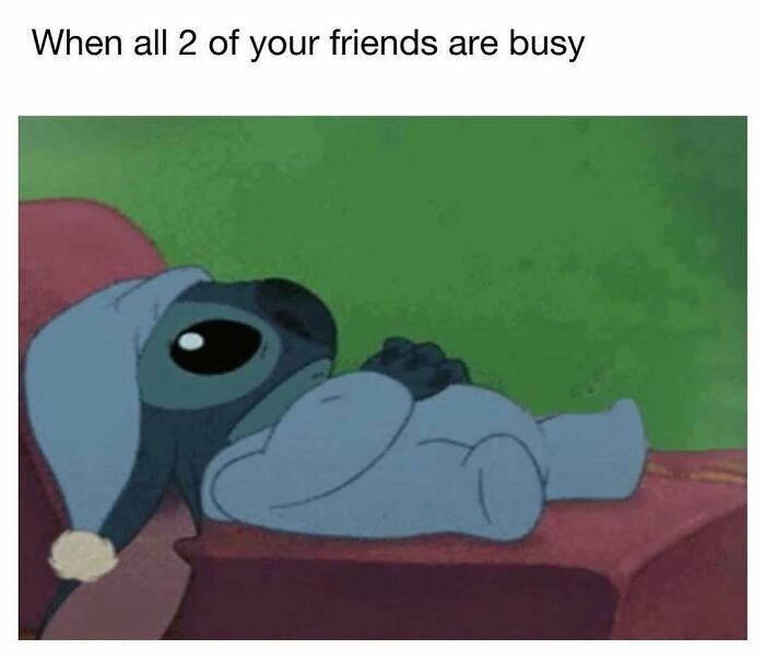 Stitch lying down looking sad and lonely, illustrating the feeling of barely holding it together when friends are busy.