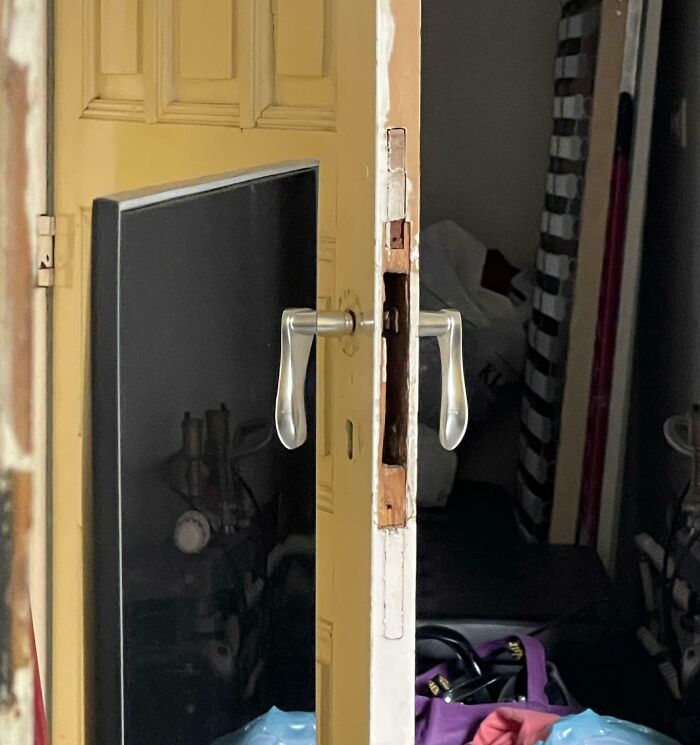 Unusual, not photoshopped image of a door with two handles, one on each side, defying typical design logic.