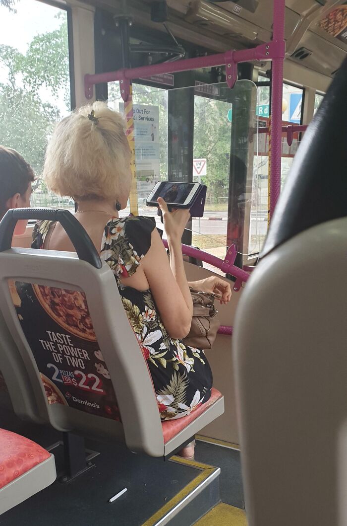Passenger watching videos loudly on public transport, causing frustration.