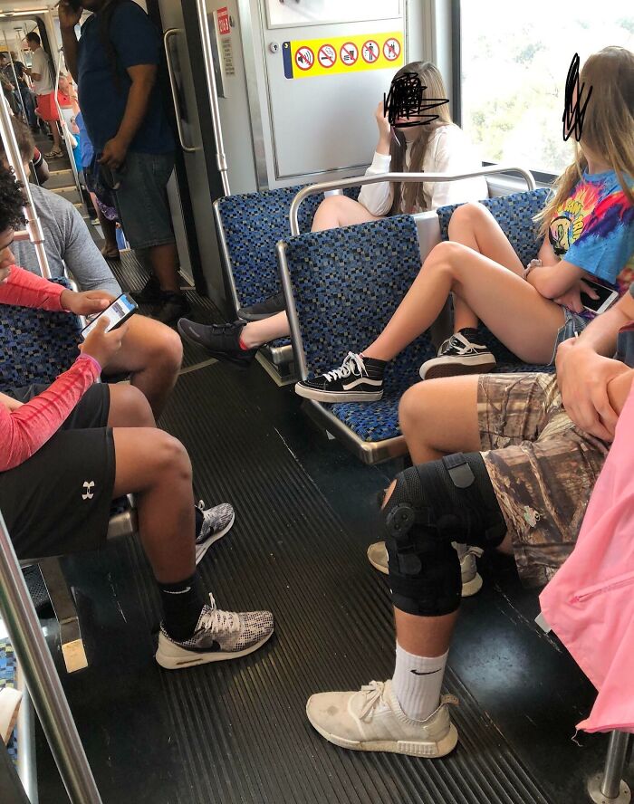 Passengers on public transport sitting with legs stretched, occupying extra space.