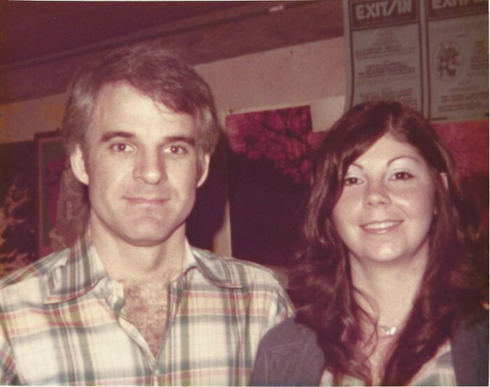 A woman smiles next to a man in a plaid shirt, representing amazing mothers-in-law.