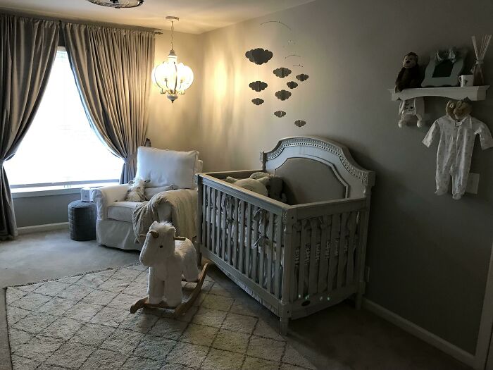 Nursery with crib, cozy chair, and a rocking horse, designed by amazing mothers-in-law.