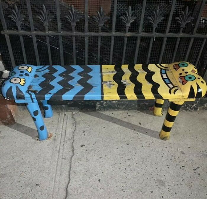 Colorful bench with quirky designs left on NYC curb for others to find.