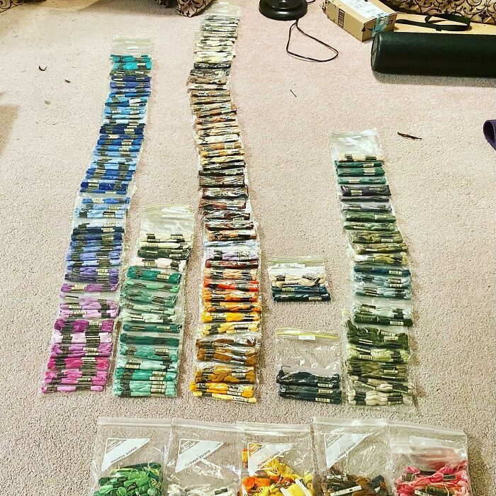 Organized embroidery threads in various colors on the floor, showcasing creativity and precision, inspired by amazing mothers-in-law.