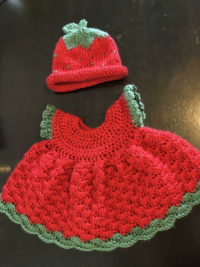 Crocheted red and green baby dress with matching hat, a thoughtful gift from amazing mothers-in-law.