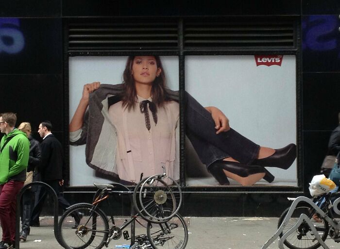 Levi's ad with comically oversized legs displayed, creating a funny ad fail effect on a busy street.